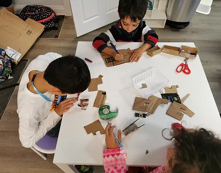 Students engaged in active learning doing arts and crafts at a table