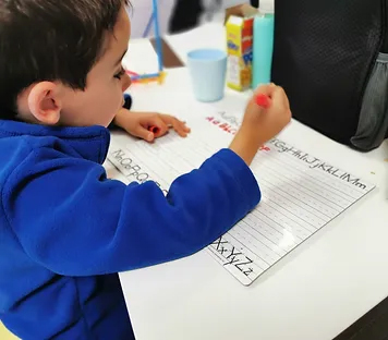 Student practicing with letters