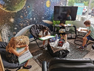 Flexible seating in alternative learning environment at Agora Prep in the Space themed room.