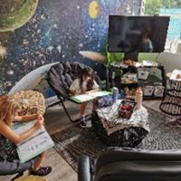 Flexible seating in alternative learning environment at Agora Prep in the Space themed room.